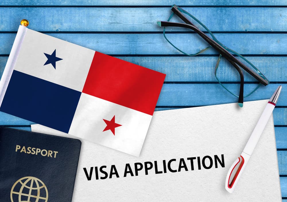 A Panamanian flag and a passport on a visa application form