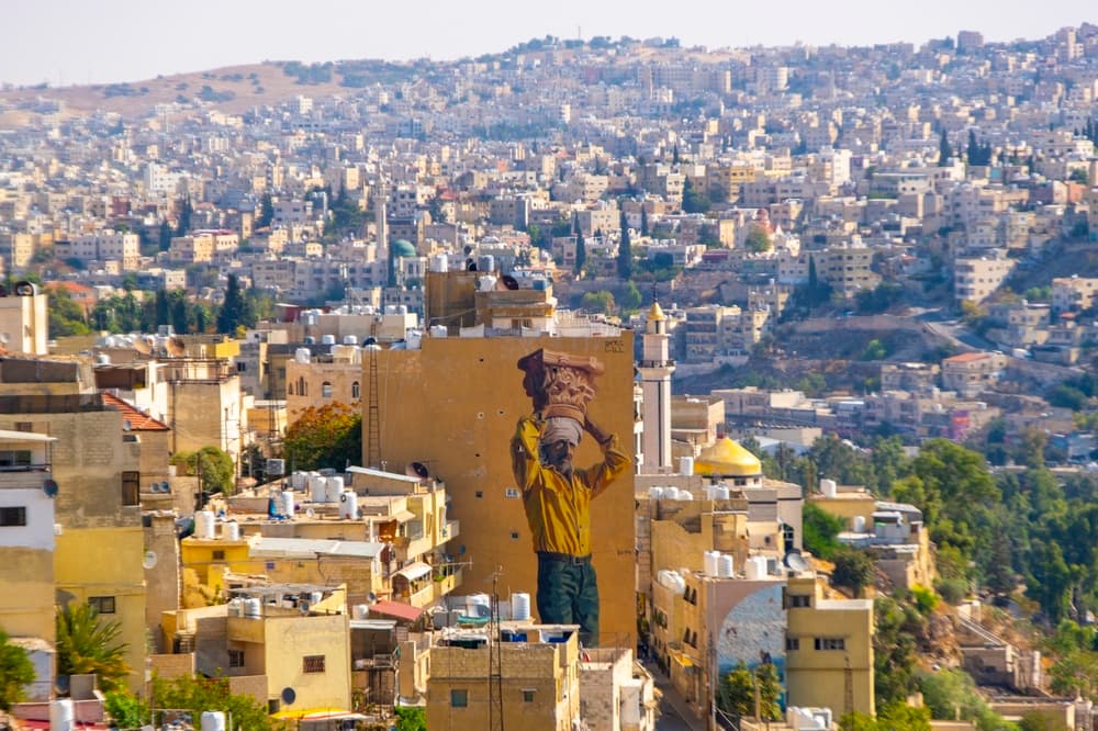 Cityscape view from the edge of town with mural, Amman