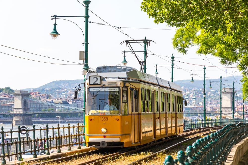 Charming yellow trolley rolls along its tracks, Budapest