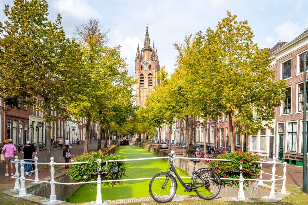 Bicycles sits alongside grassy pavilion, Delft