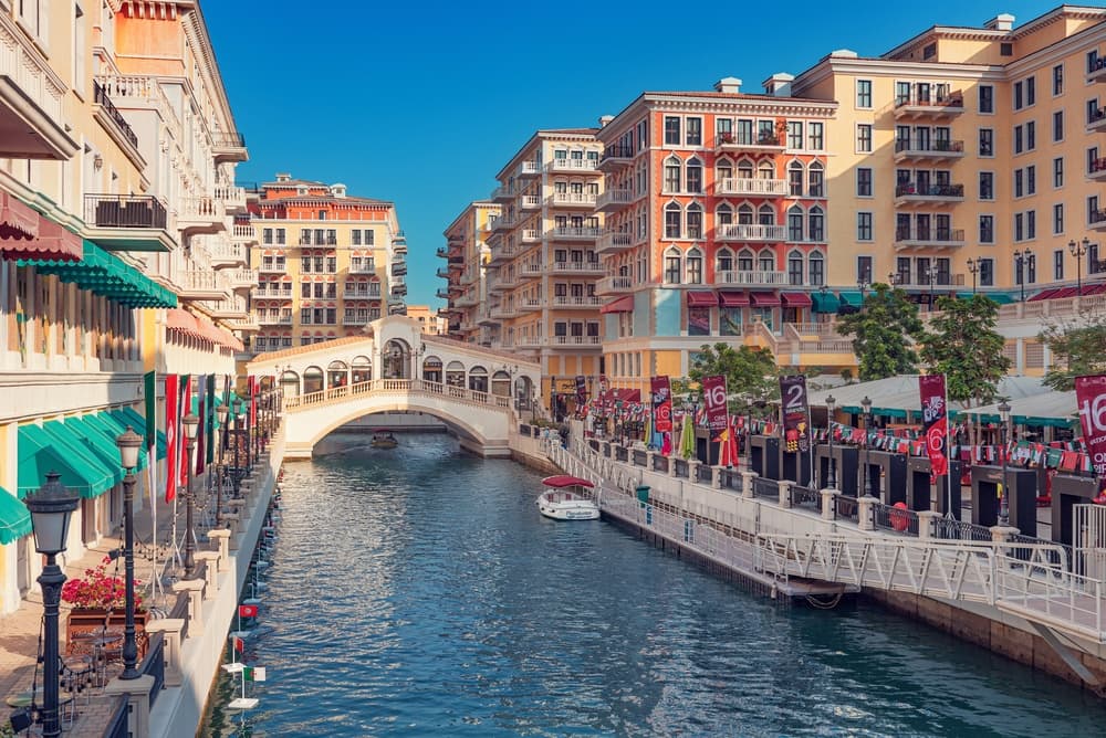 Boat floats along river running through the city, Doha