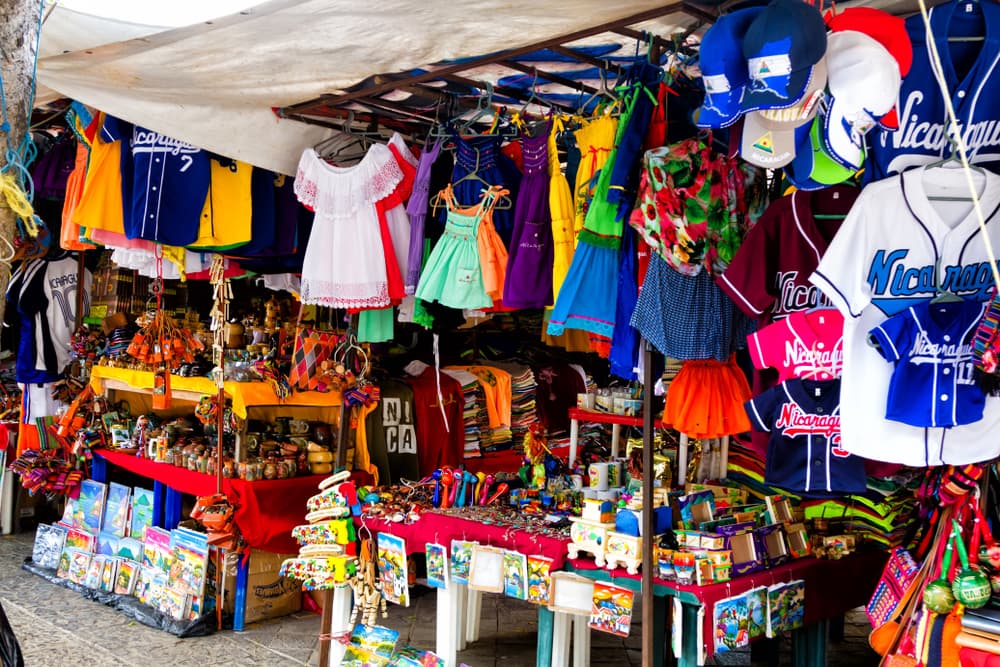 Brightly colored clothes on sale by tent vendor, Granada