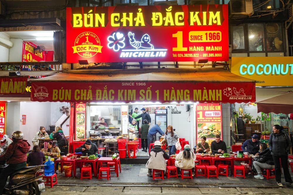 Diners eat outside Michelin star Bun Cha Dac Kim restaurant, Hanoi