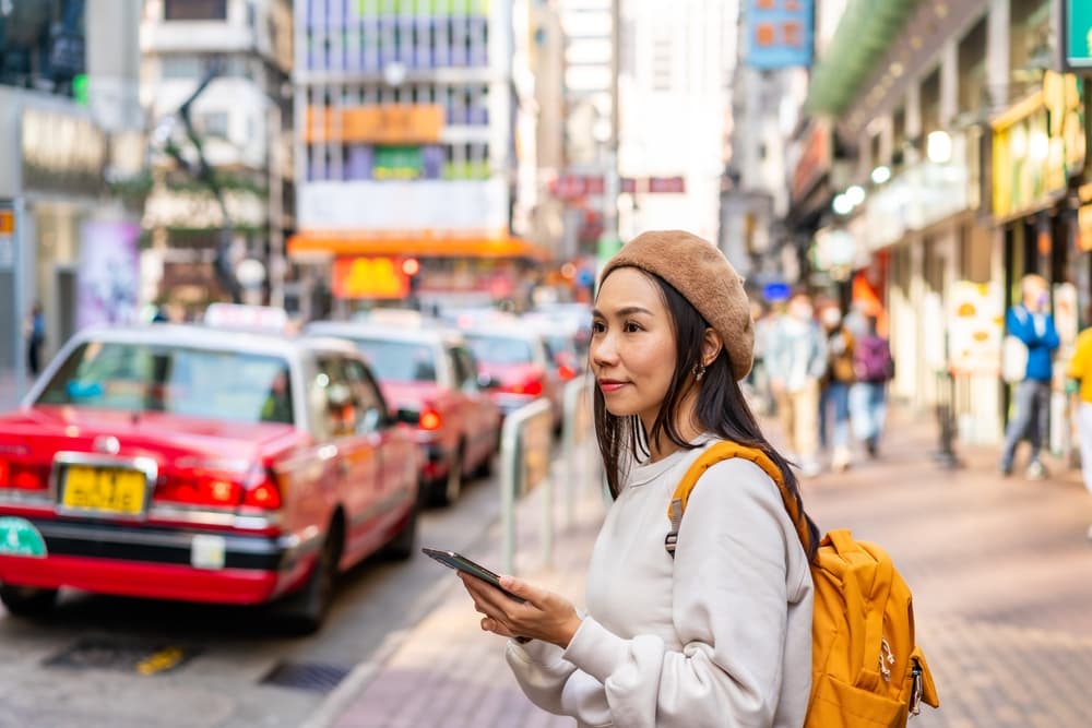 Chinese woman navigates the city with her map, Hong Kong