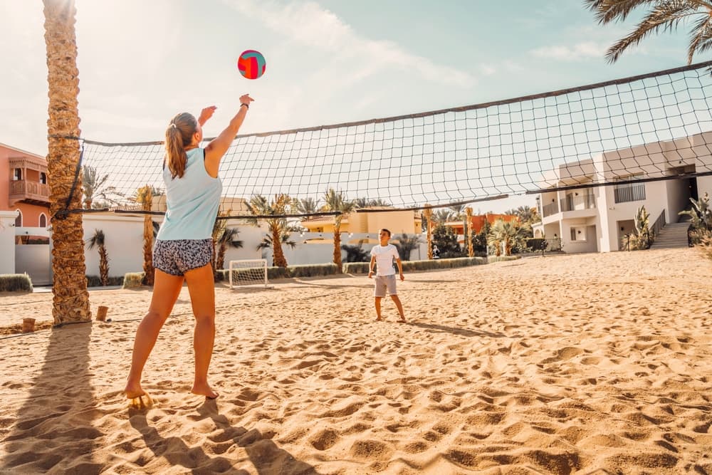 City visitors play beach volleyball, Hurghada