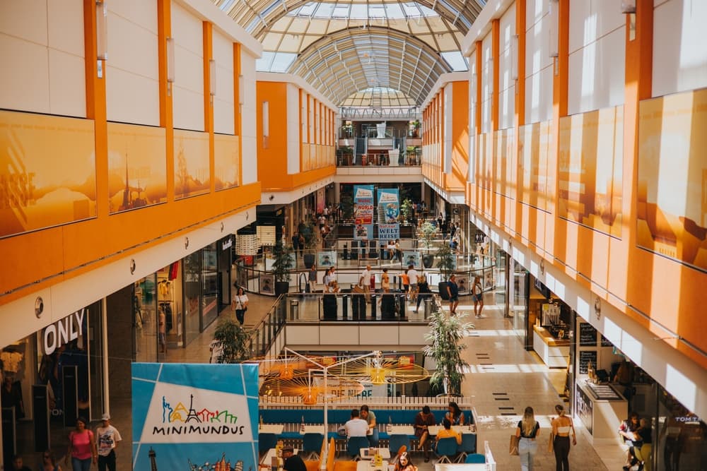 Busy shopping mall lit up for afternoon guests, Klagenfurt
