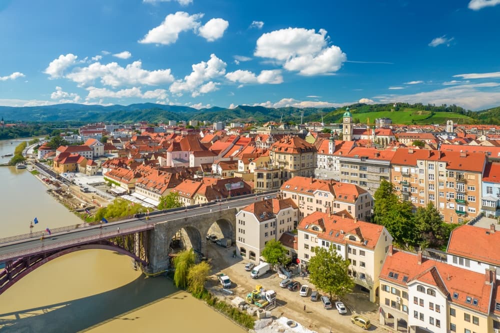 Cityscape revealed by river and bridge, Maribor