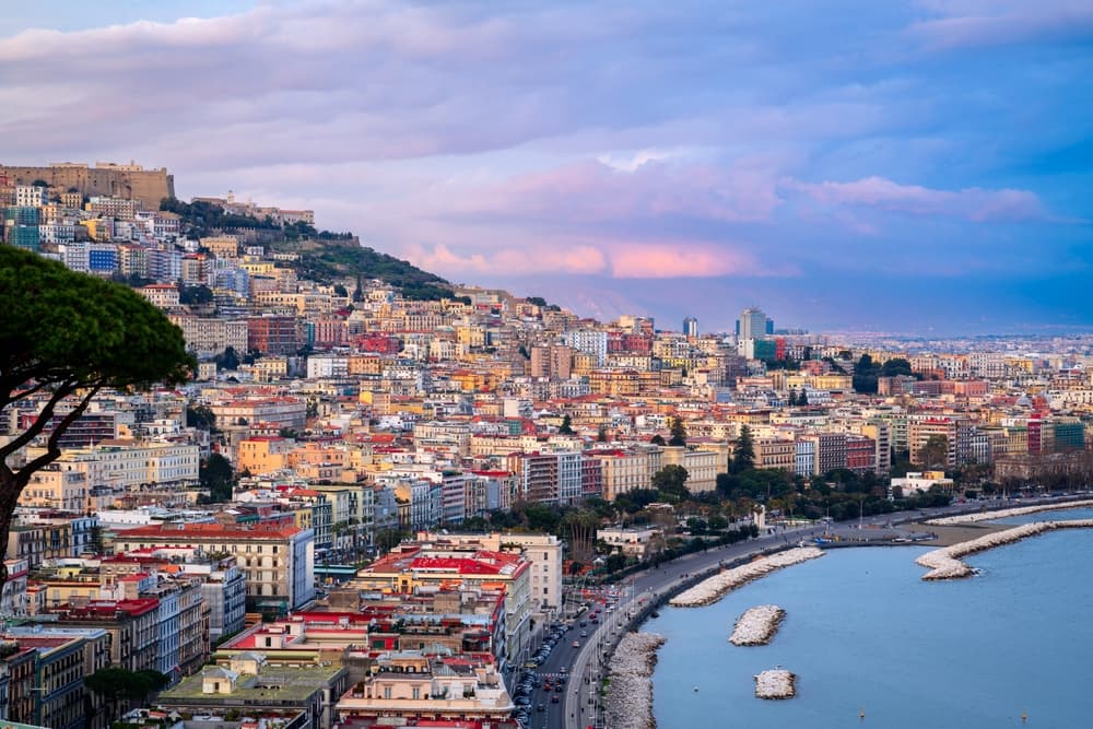 Aerial view of the full city by the gulf at twilight, Naples