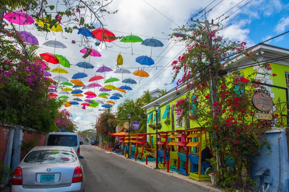 Bright umbrellas hang over street, Nassau