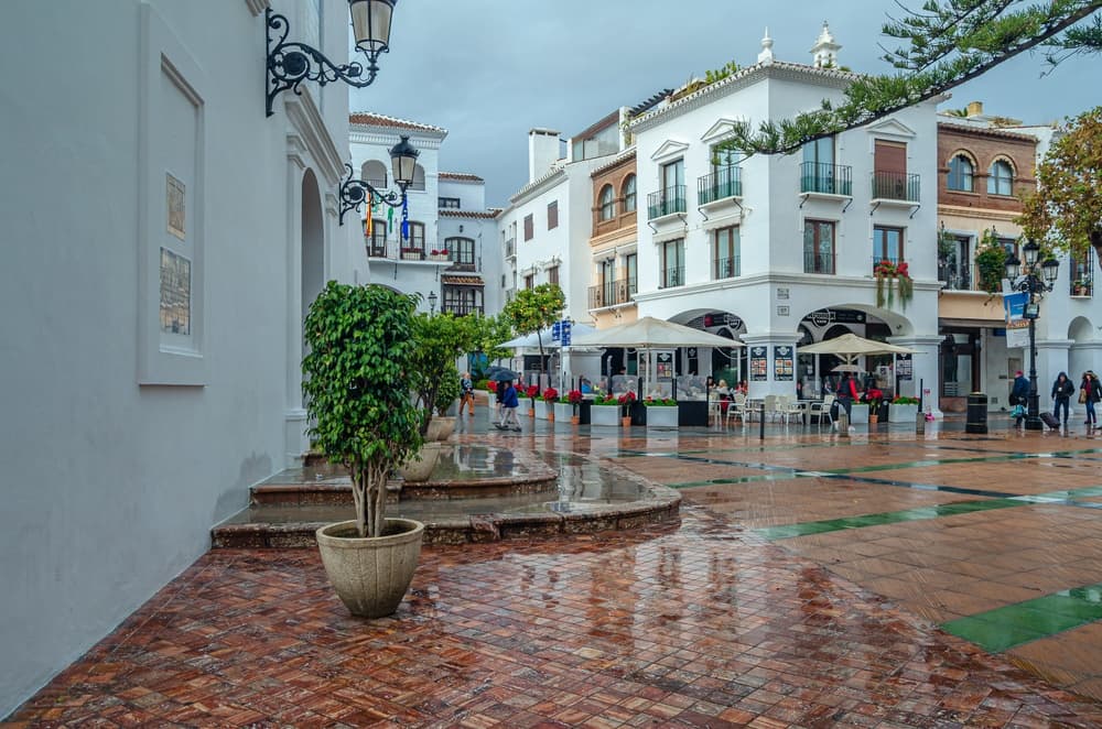 Cafes sit open in town center on rainy day, Nerja