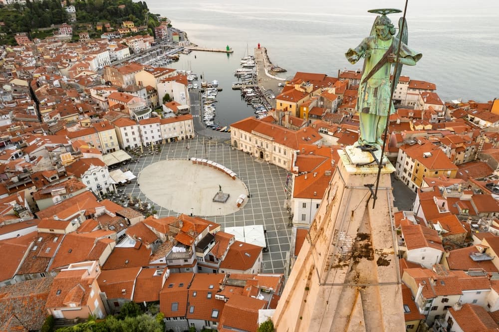 Angel statue looks down on city center, Piran