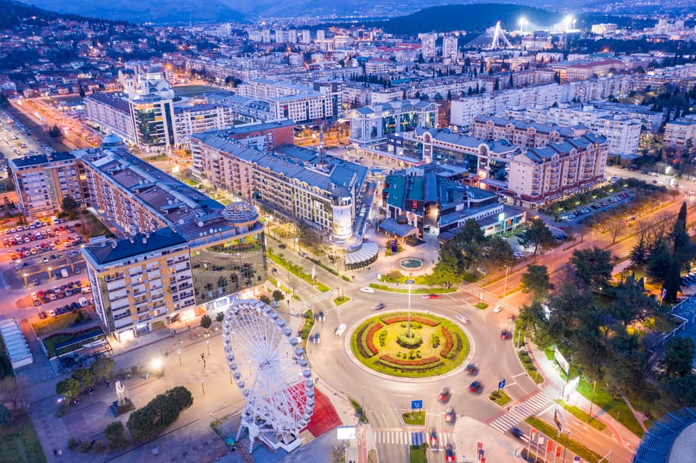City center lit up in evening with Ferris wheel, Podgorica