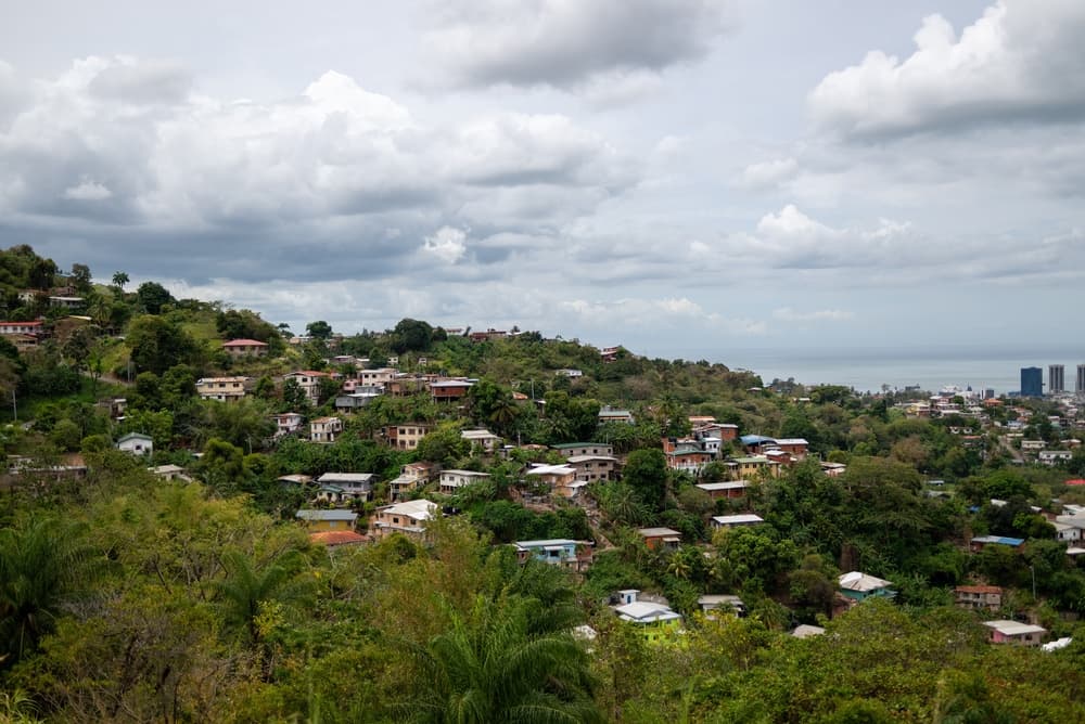 Trinidad homes sparsely populated between trees on hillside, Port of Spain