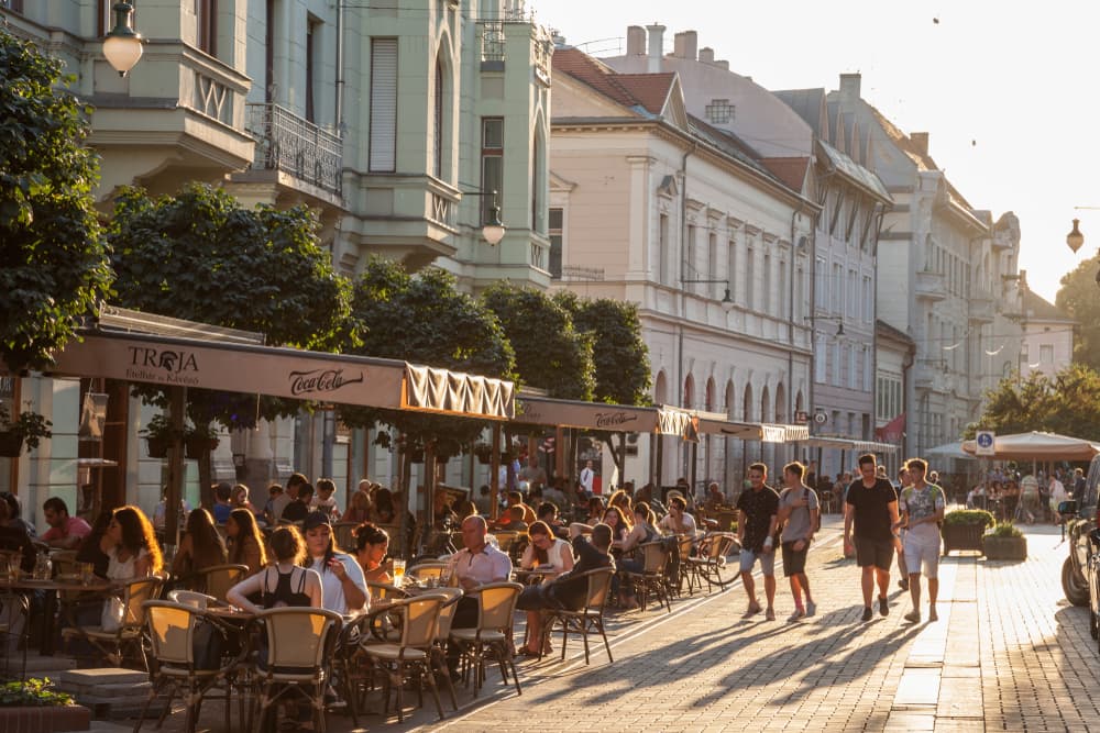Lively outdoor cafes filled in late afternoon, Szeged