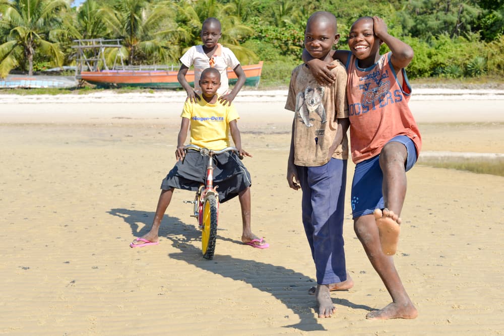 Boys posting for the camera with their bike, Vilankulo