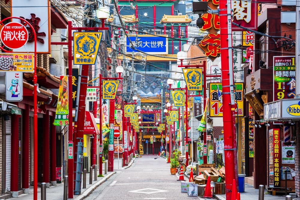Bicycle lane flows between shops and many signs, Yokohama