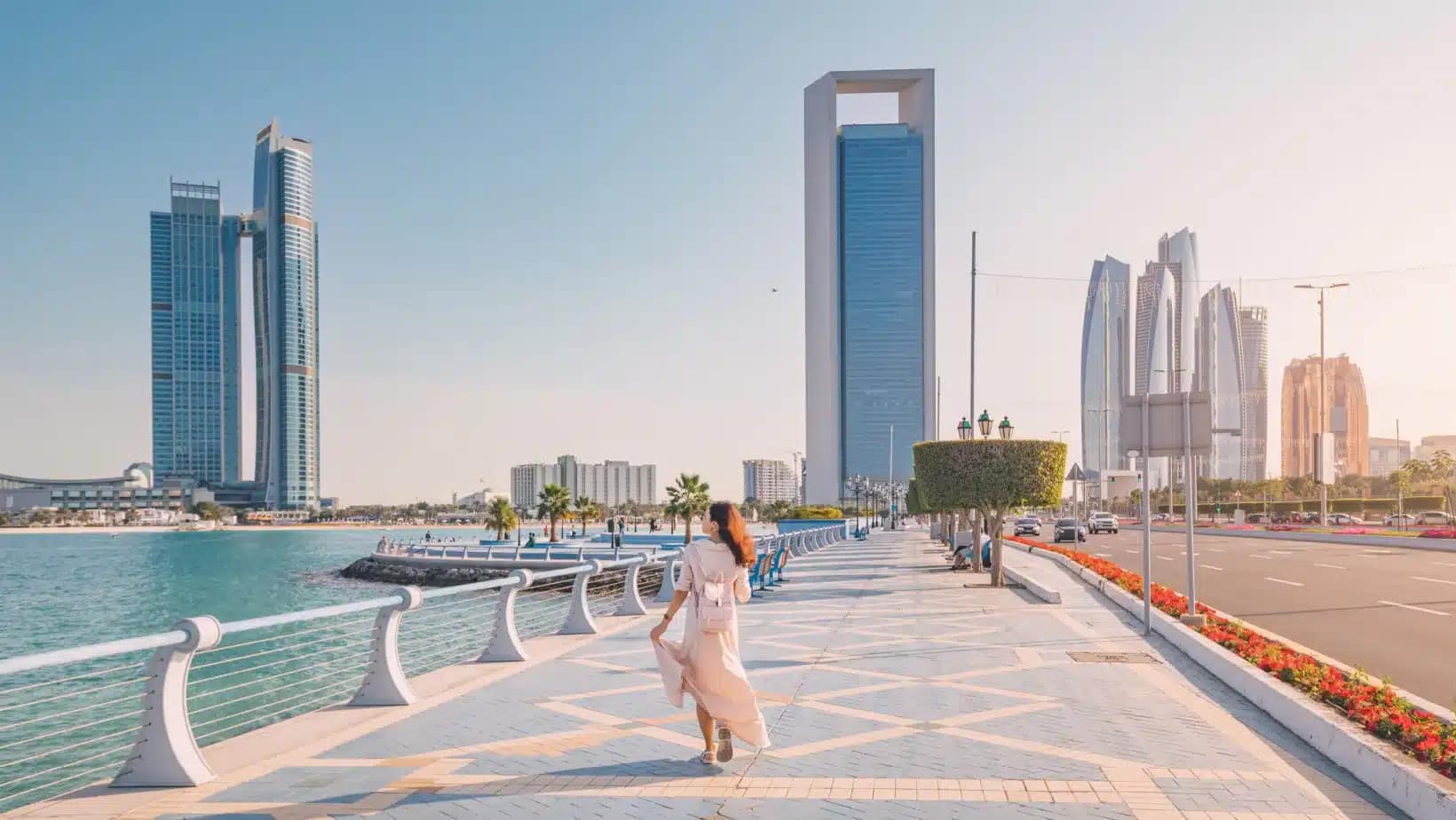 The waterfront promenade on the Abu Dhabi Corniche with towers behind it