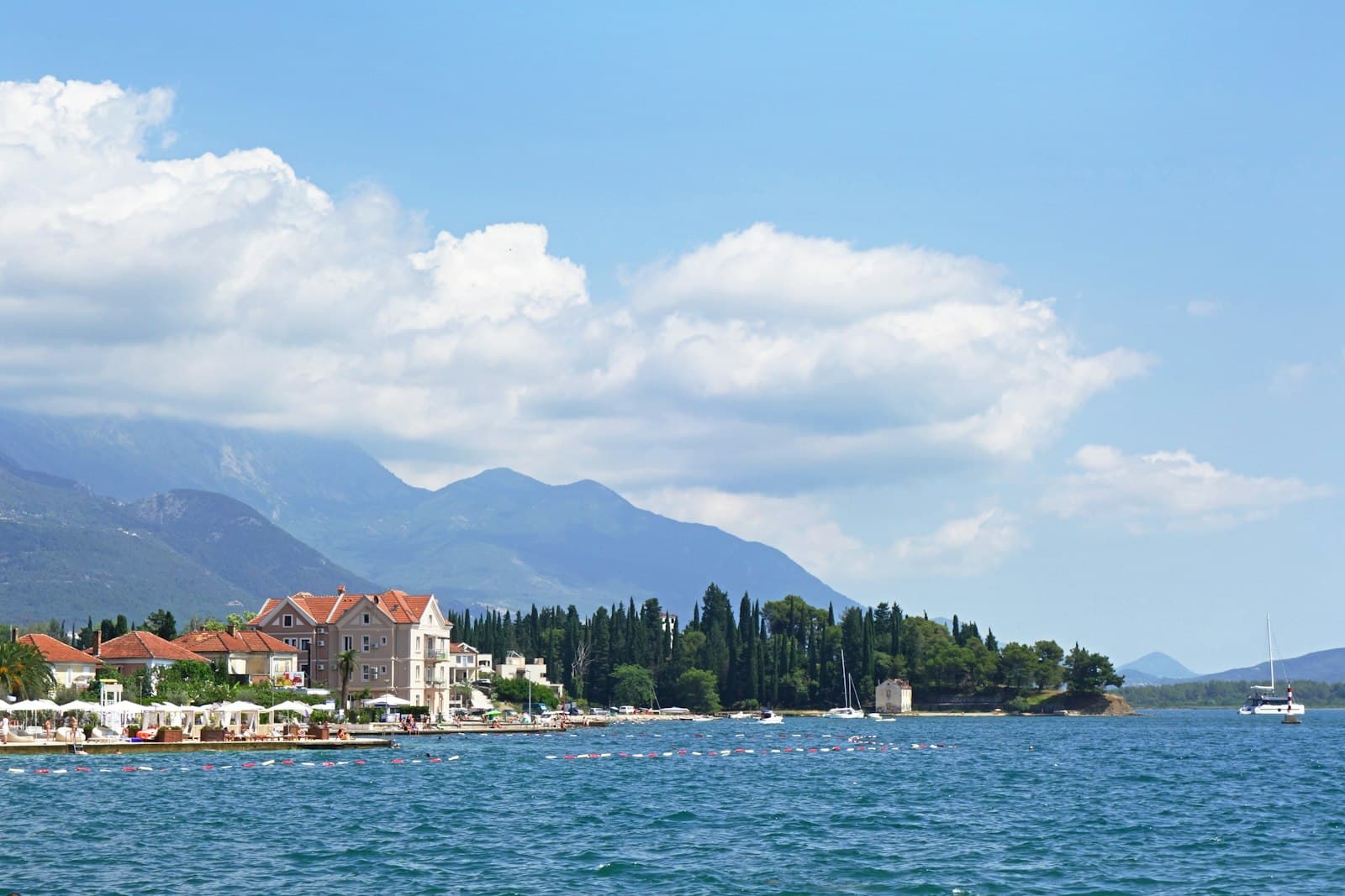 Villas and cypress trees on the waterfront in Tivat, on the Bay of Kotor