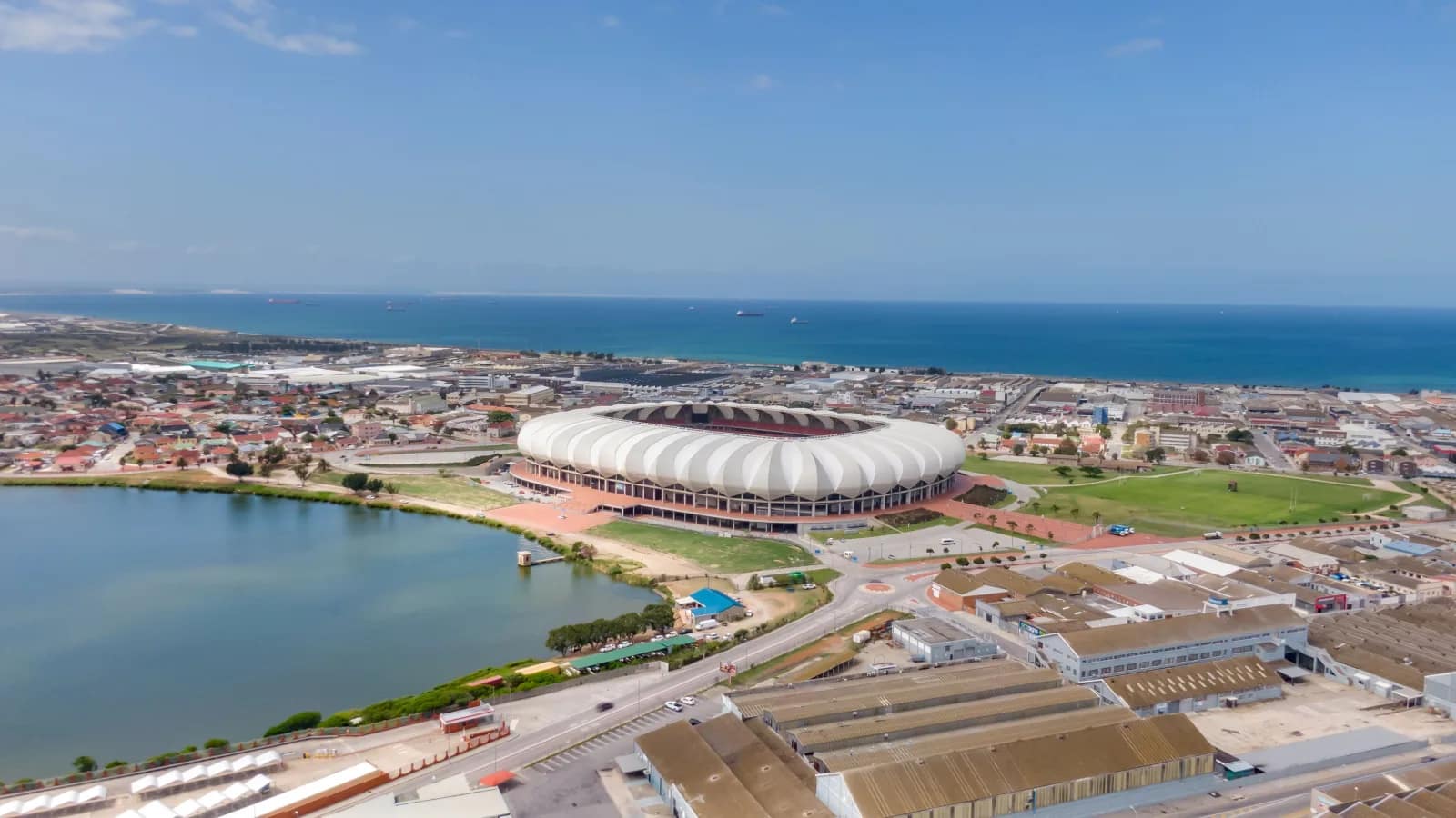 Aerial view of Gqeberha, South Africa, with the stadium, a lake and the Indian Ocean