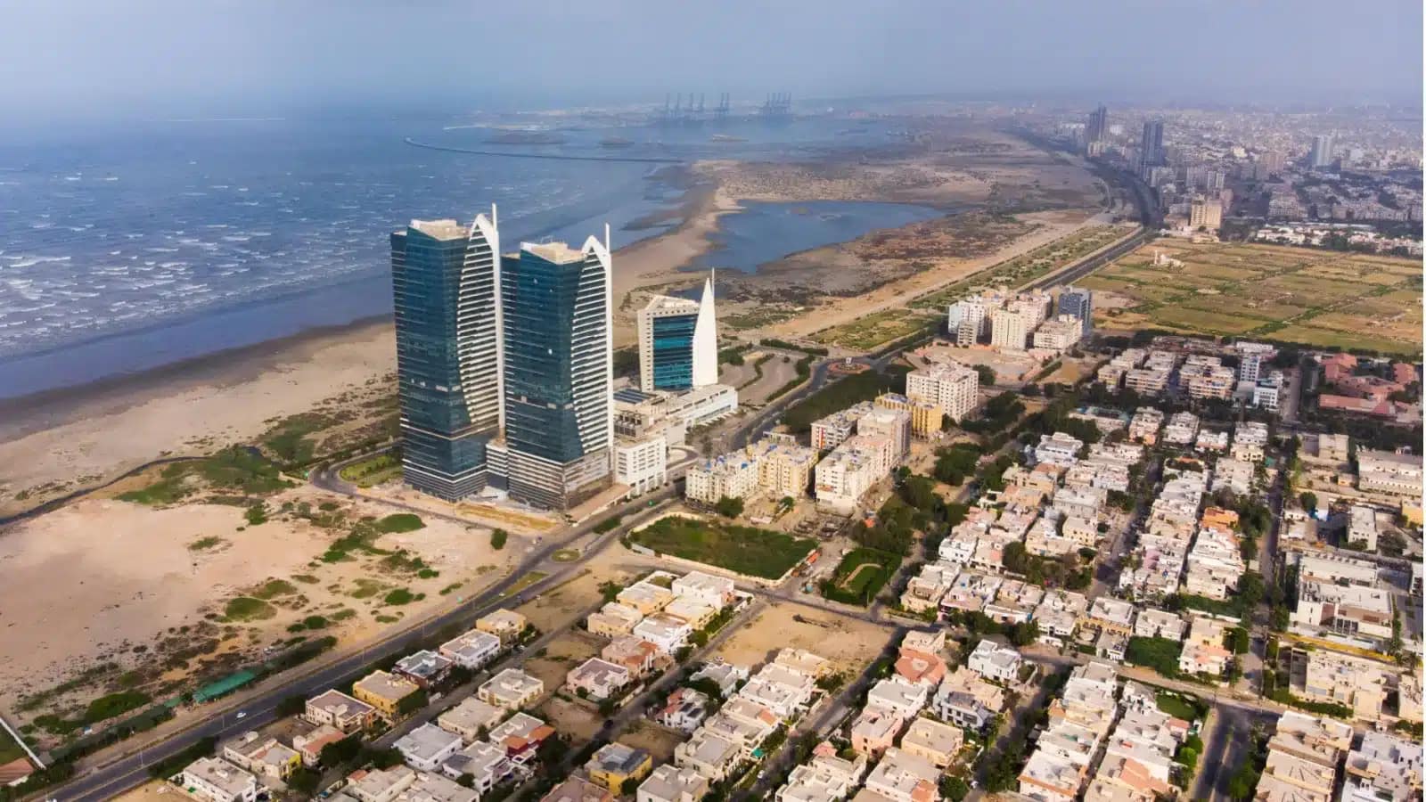 Aerial view of Karachi's coastline with high-rise towers beside the Arabian Sea