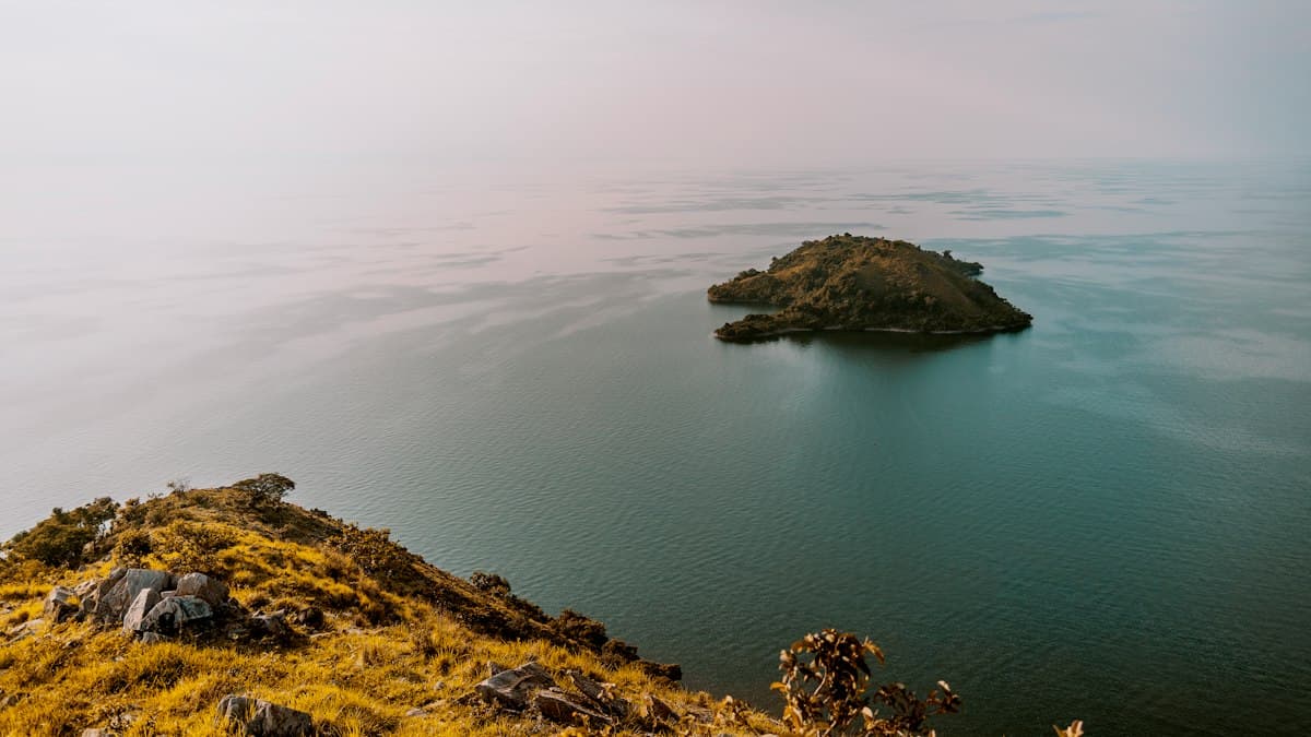 A small green island in the calm water of Lake Kivu, Rwanda