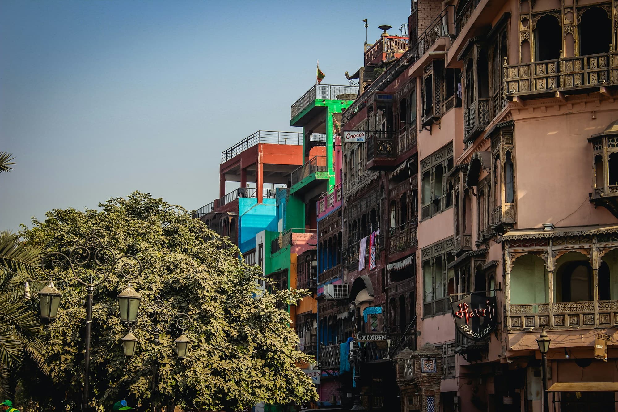 Colorful old buildings with carved wooden balconies along a street in Lahore's Walled City