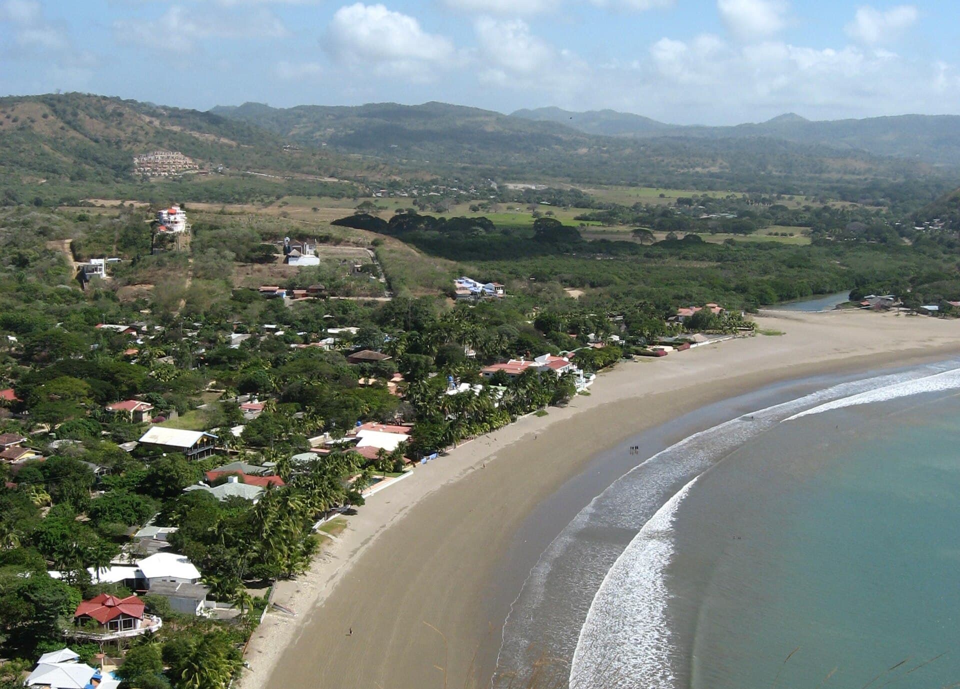 Aerial view of the curved bay and beach town of San Juan del Sur on Nicaragua's Pacific coast