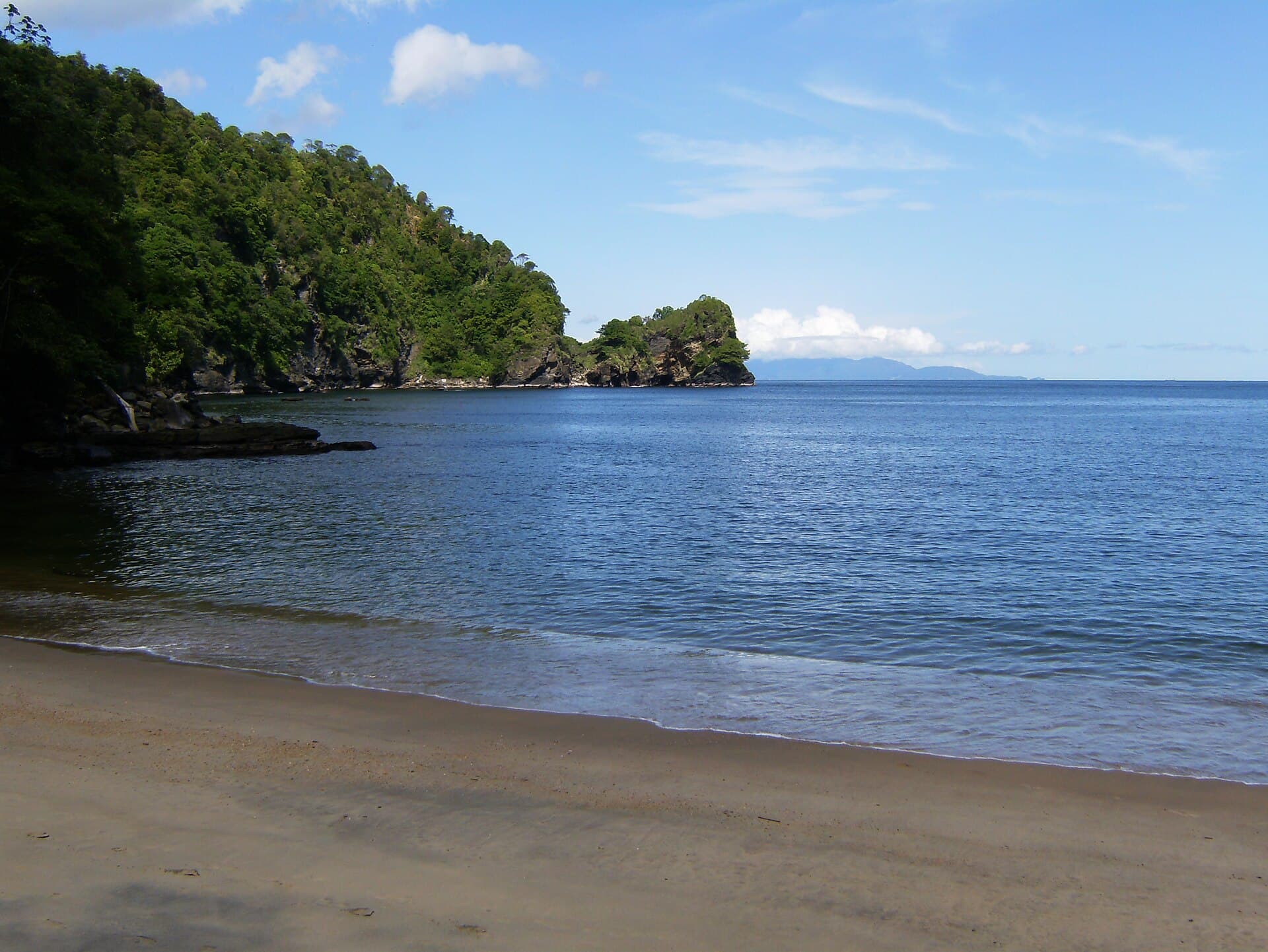 Quiet sandy beach and forested headland at Macqueripe Bay in Chaguaramas, Trinidad