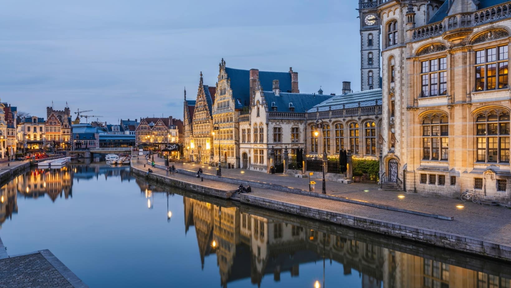 Guild houses along the Graslei canal in Ghent at dusk