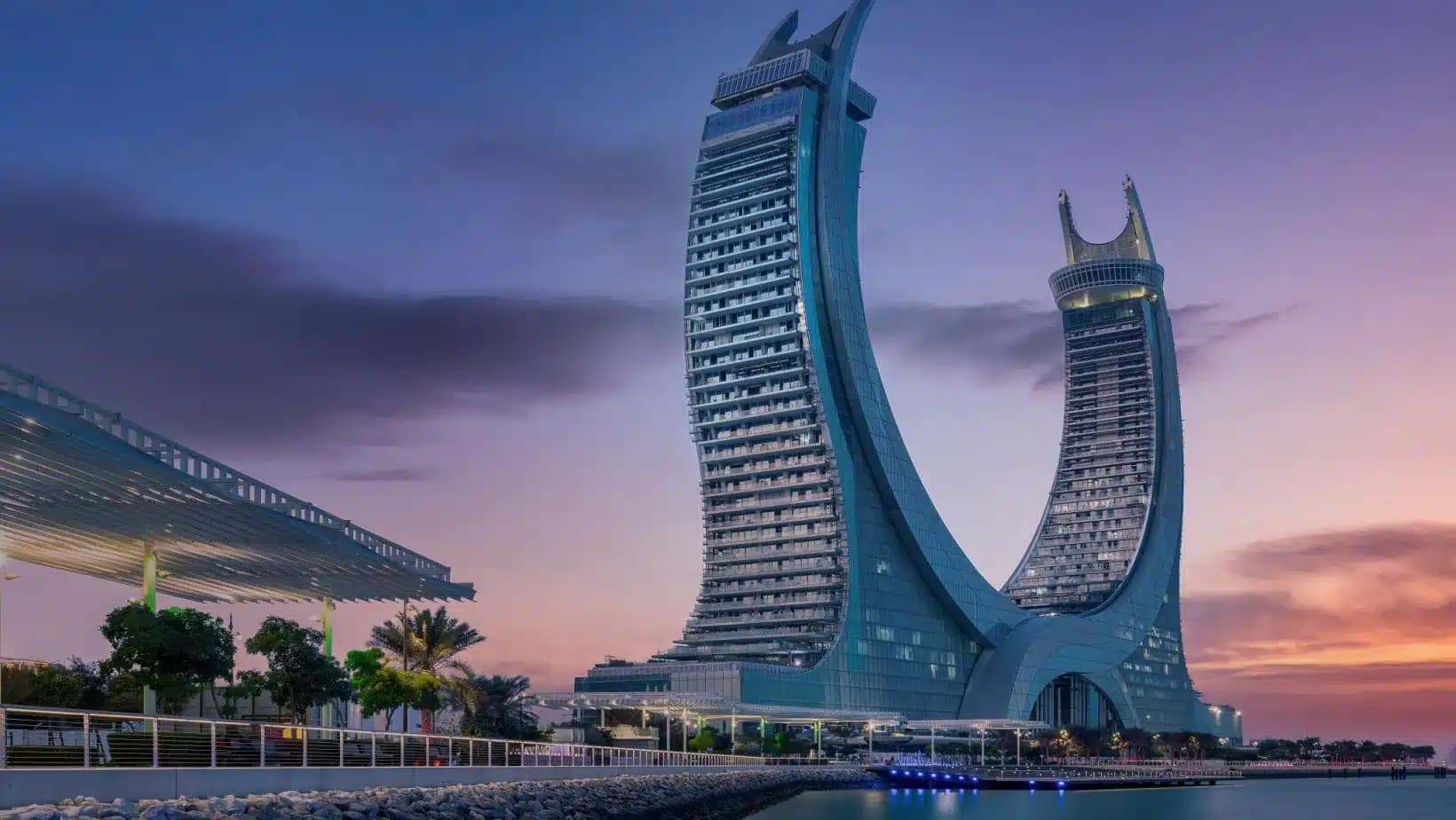 The crescent-shaped Katara Towers in Lusail at dusk