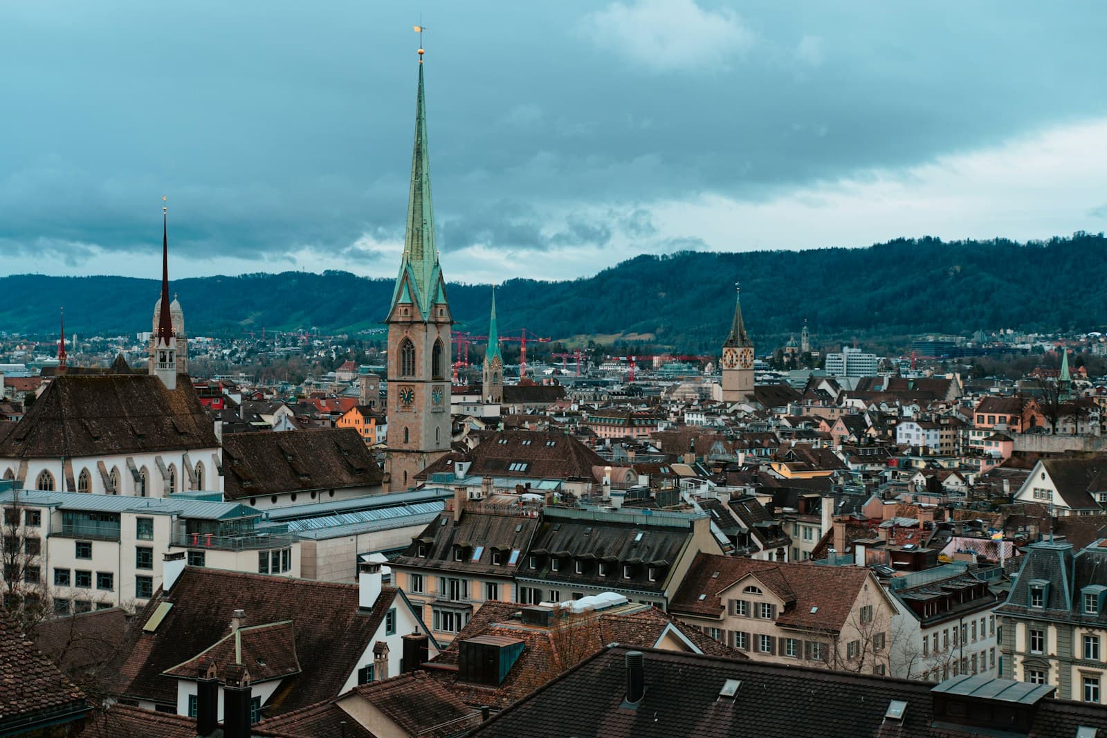 Zurich's old town rooftops and church spires under a cloudy sky