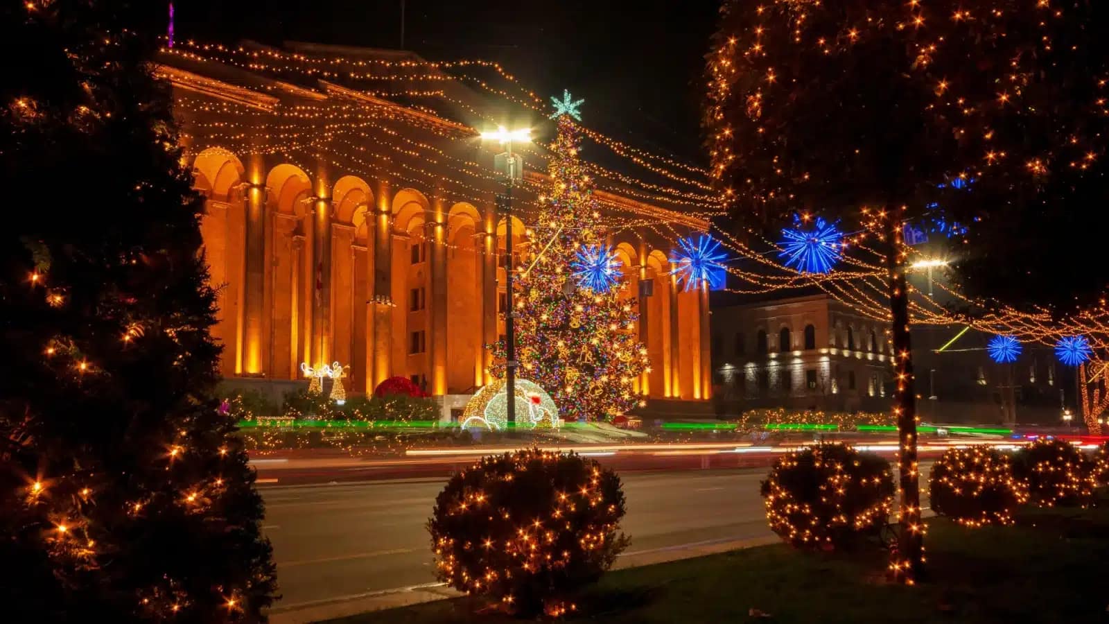 Georgia's former Parliament building on Rustaveli Avenue in Tbilisi, lit up with holiday lights at night