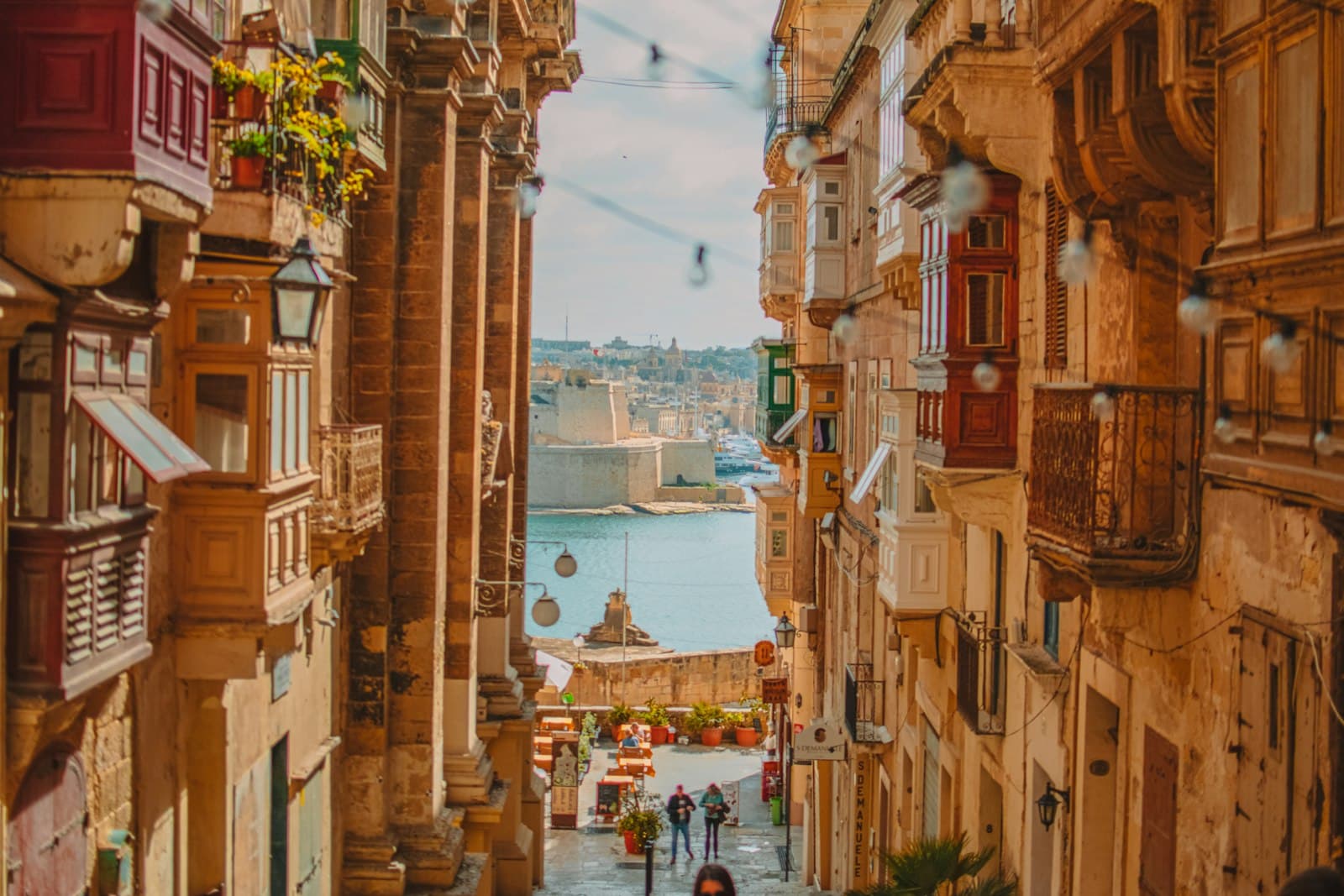 A Valletta street of traditional wooden balconies leading down to the Grand Harbour