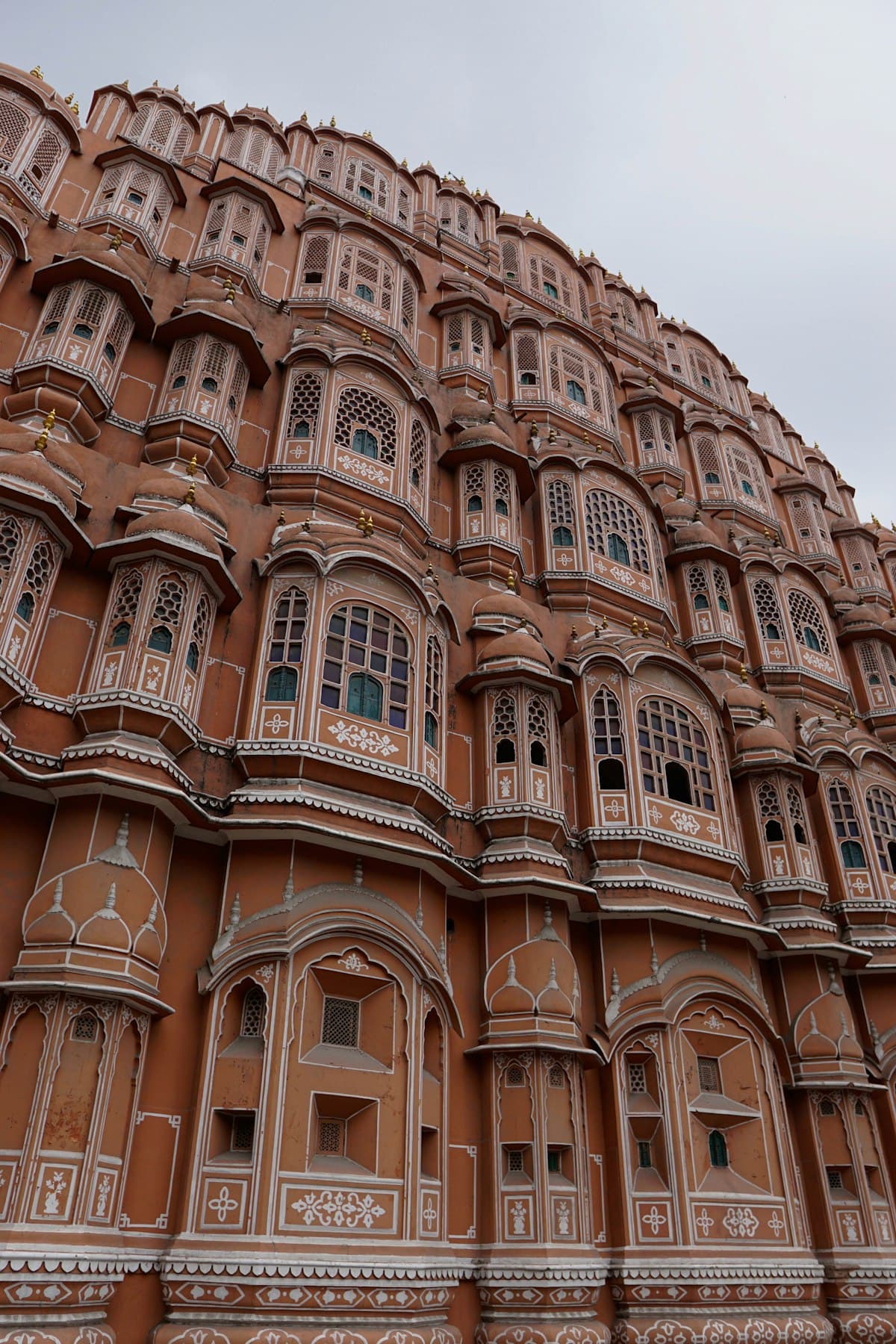 The pink sandstone facade of the Hawa Mahal in Jaipur