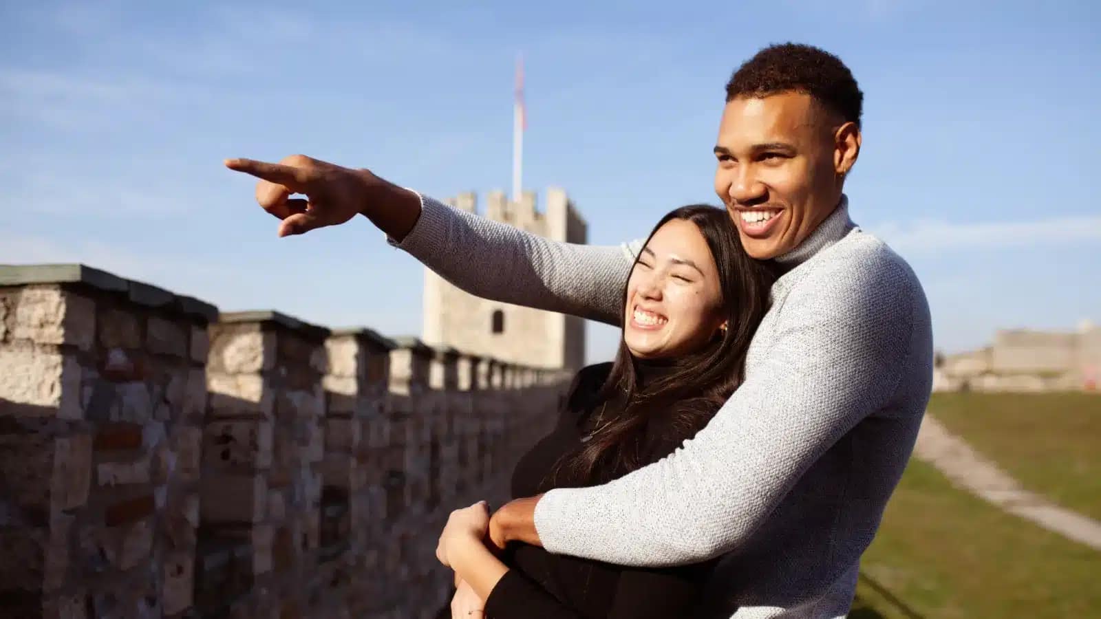 A couple on the stone walls of Skopje Fortress on a sunny day