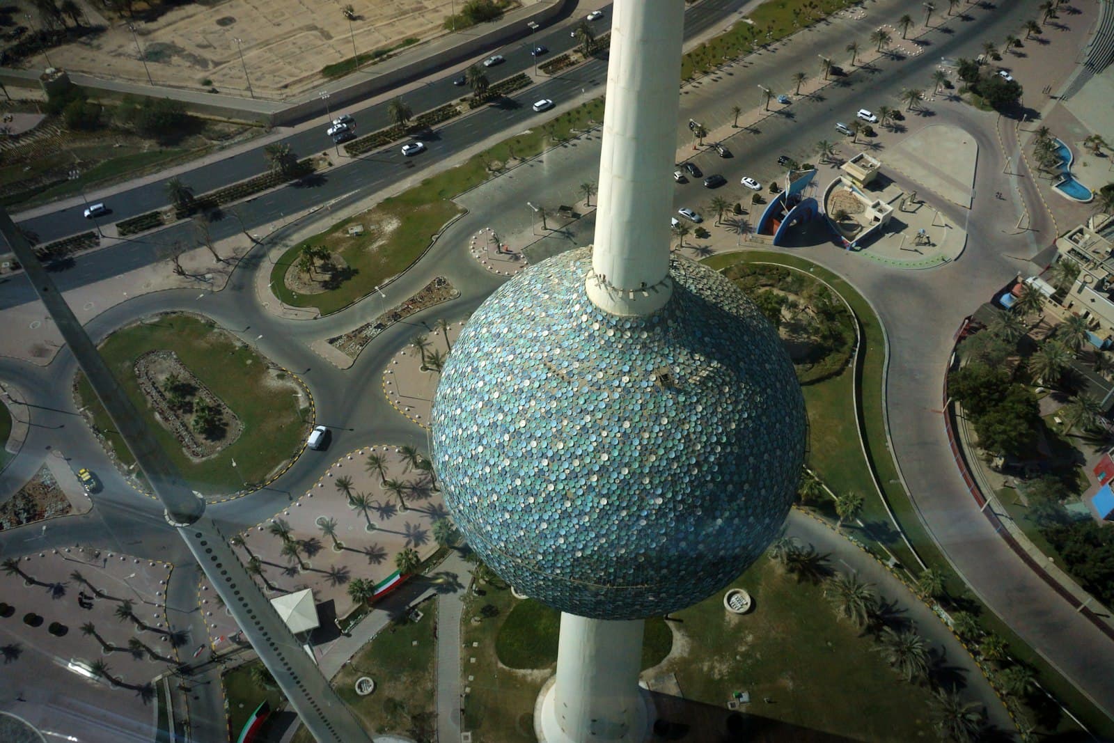 Looking down on the tiled sphere of the Kuwait Towers and the seafront roads below