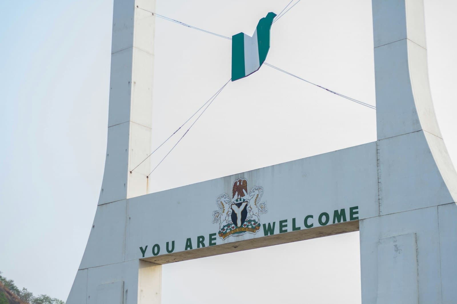 The Abuja city gate with the Nigerian coat of arms and a You Are Welcome sign