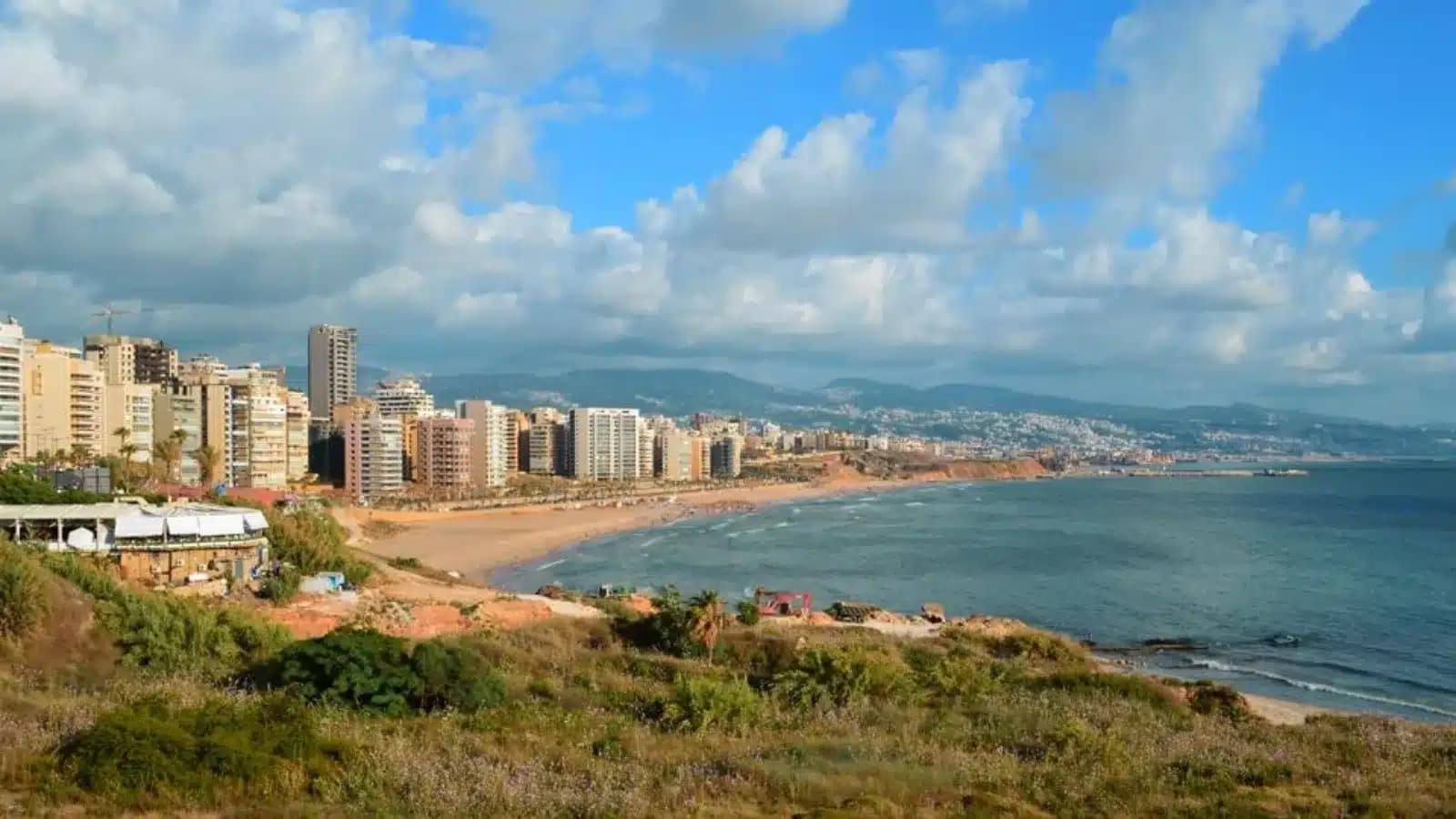 Apartment towers above Ramlet al-Baida beach in Beirut, with Mount Lebanon behind