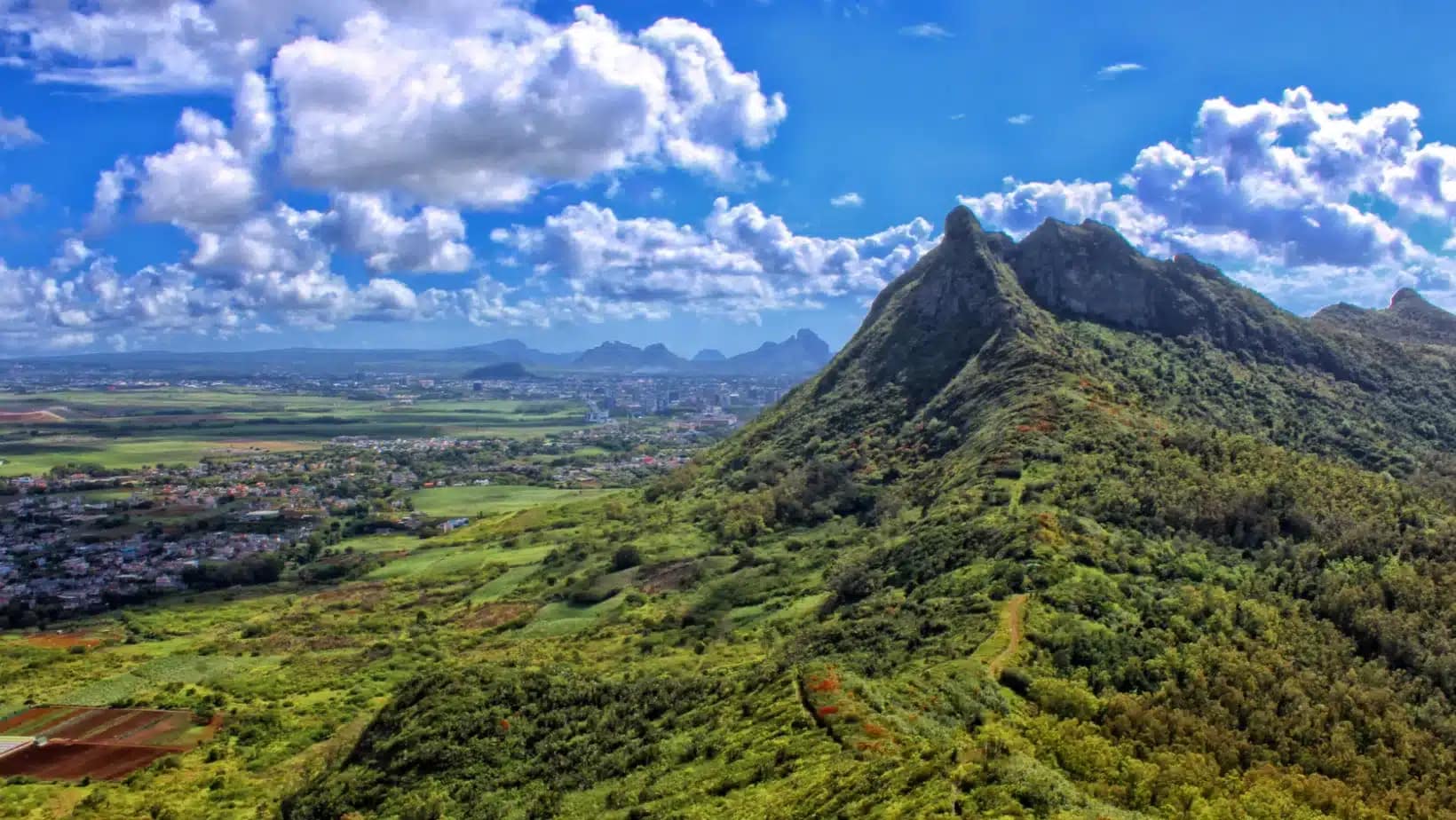 Green mountain peaks rising above farmland and villages near Moka, Mauritius