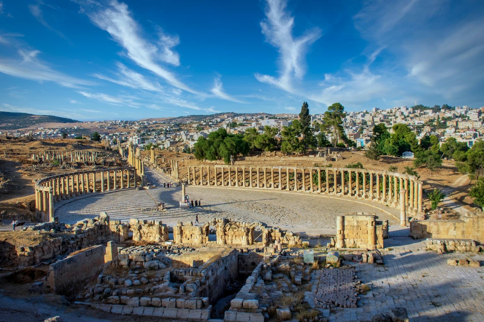The Roman Oval Plaza at Jerash with the modern town on the hills behind it, north of Amman