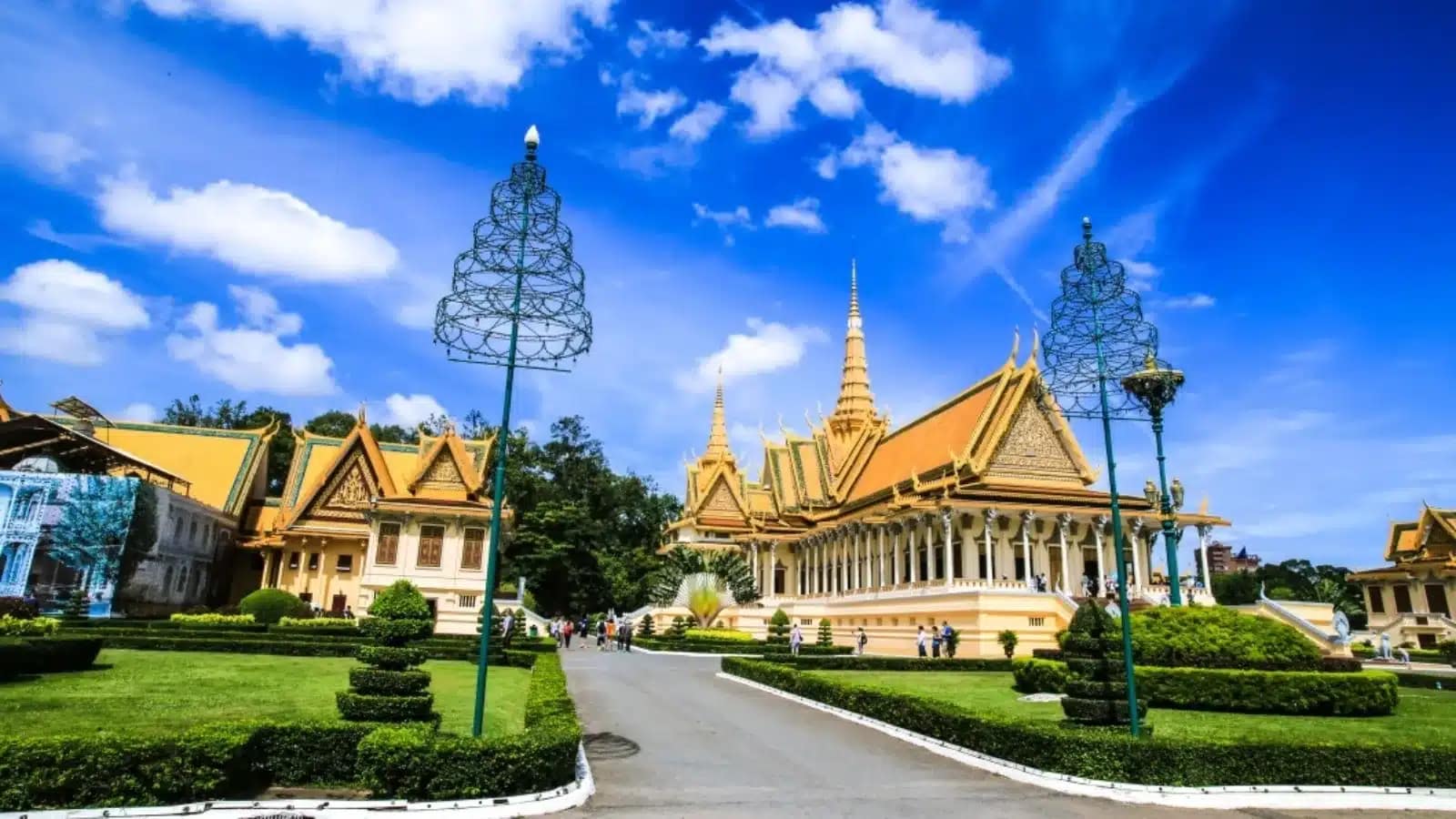 The Royal Palace throne hall and gardens in Phnom Penh under a blue sky