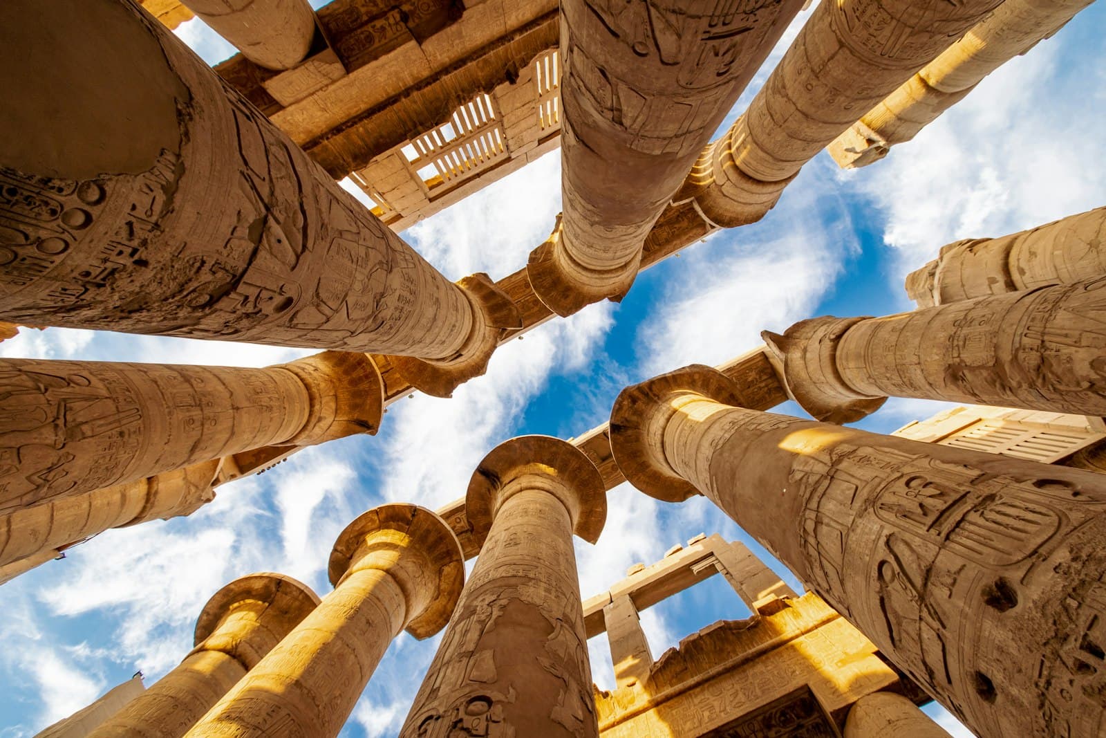 Looking up at the carved columns of the Karnak temple hypostyle hall in Luxor