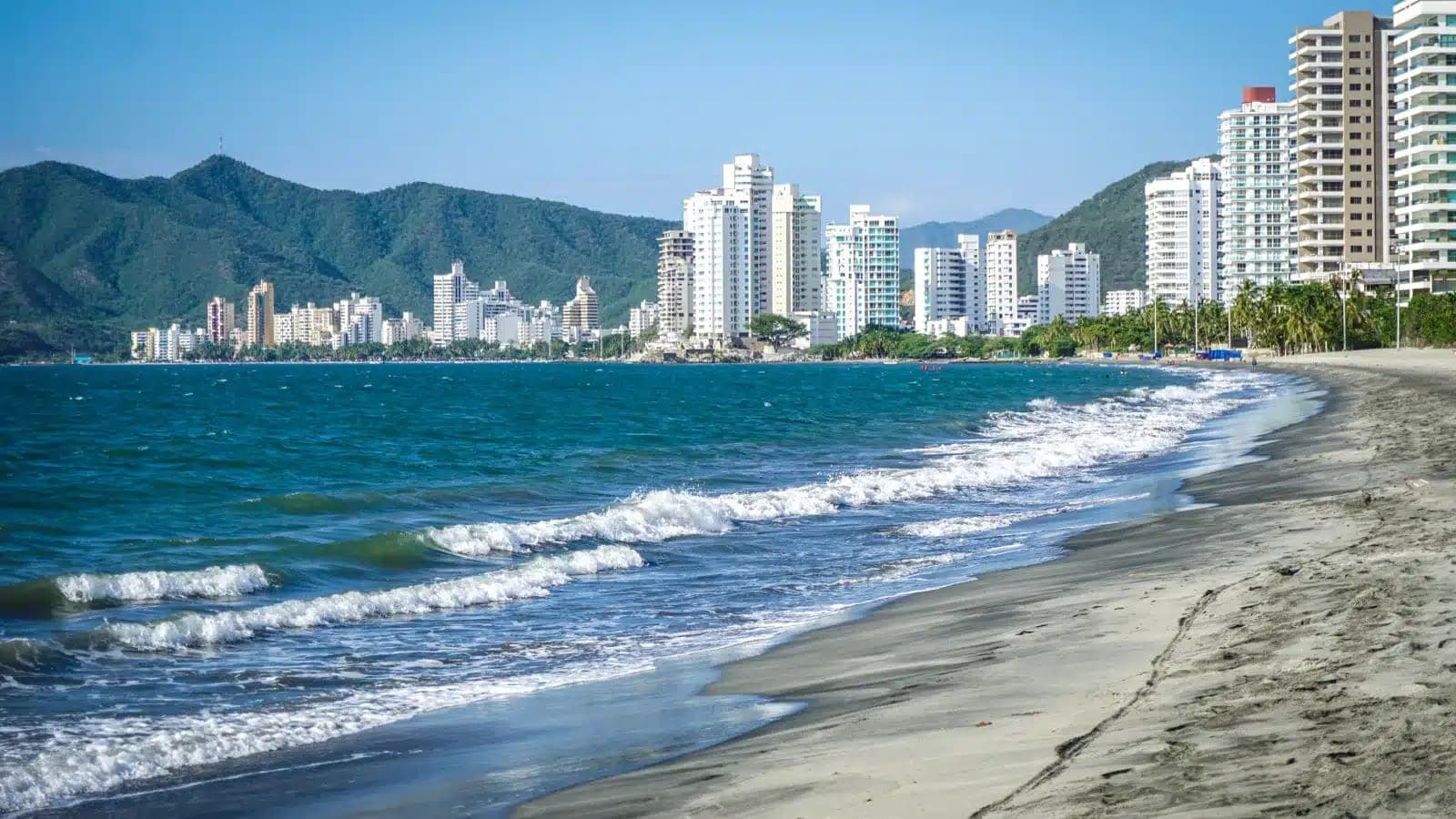 High-rise apartments along a curving Caribbean beach in Santa Marta, Colombia