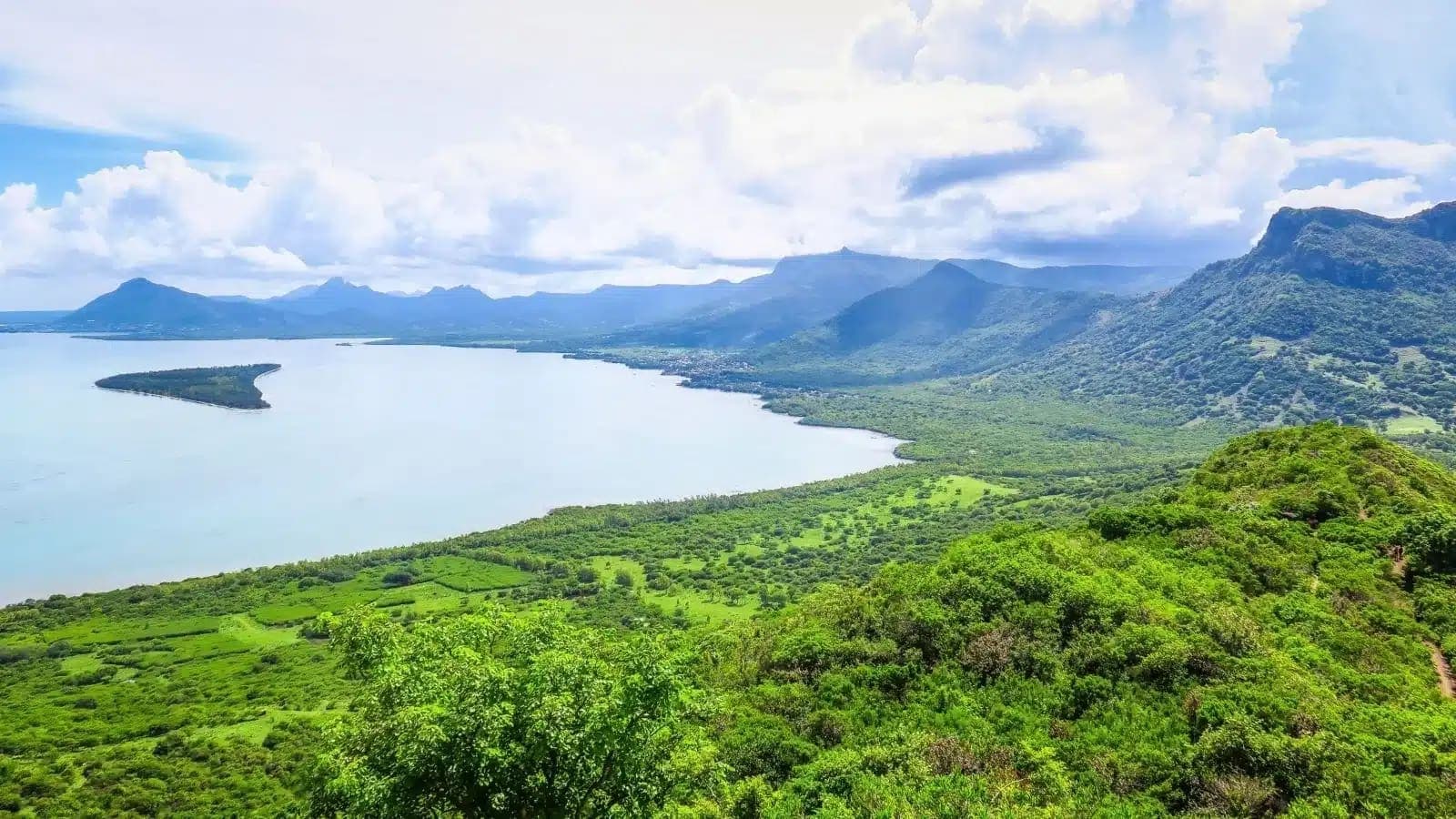 Green hills sloping down to a wide lagoon on the west coast of Mauritius