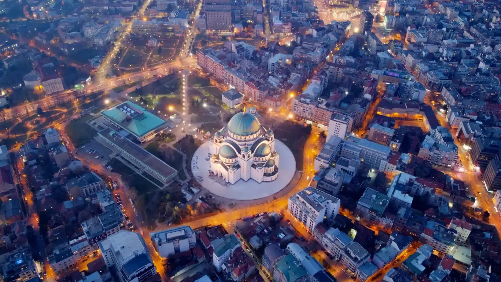 Aerial view of Belgrade at dusk with the Church of Saint Sava lit up