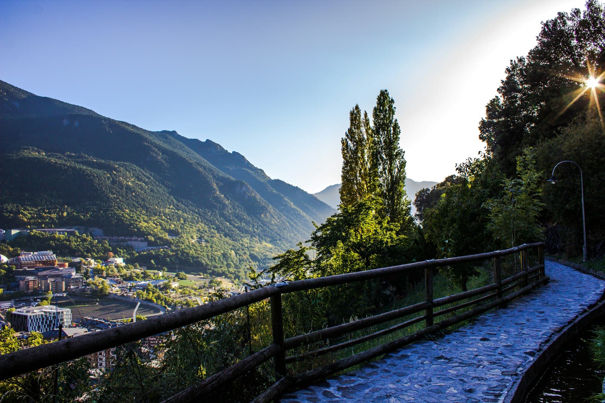 A stone footpath above Andorra la Vella with the valley and mountains beyond