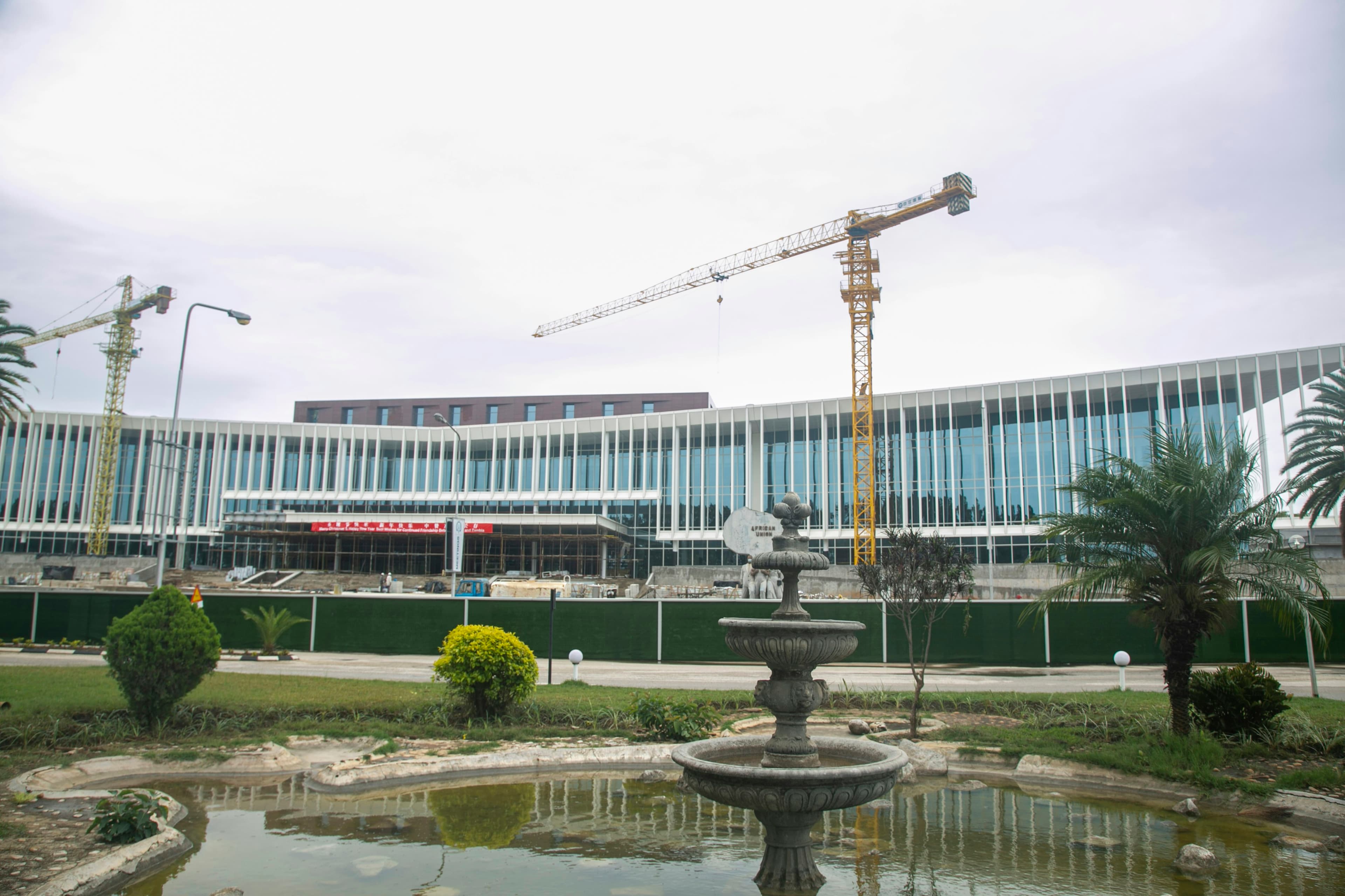 The new Mulungushi International Conference Centre in Lusaka under construction, with tower cranes behind a stone fountain