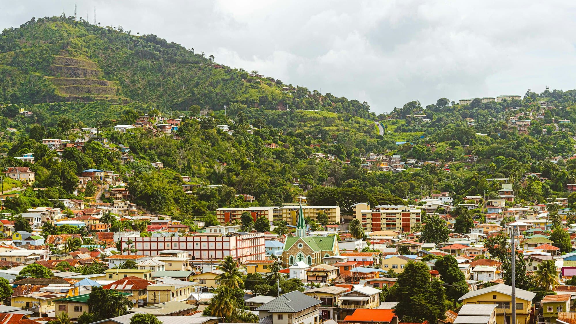 Colorful houses climbing green hills above Port of Spain, Trinidad
