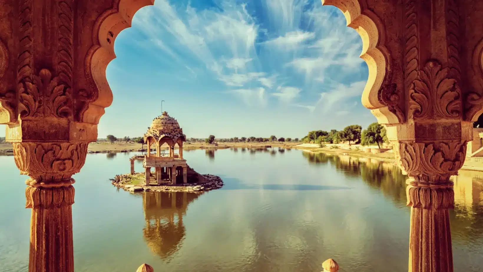 Gadisar Lake in Jaisalmer, Rajasthan, framed by a carved sandstone arch