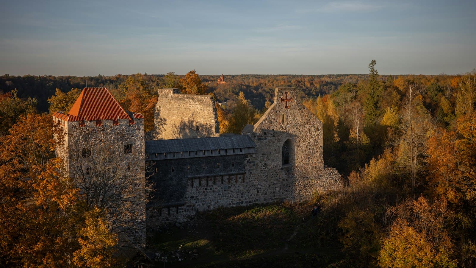 Sigulda medieval castle ruins above autumn forest in the Gauja valley